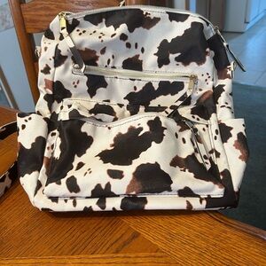 Chic Cow Print Backpack with Gold Details